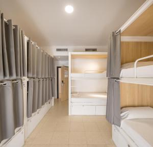 a group of bunk beds in a dorm room at UP Hostel Valencia in Valencia