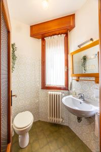 a bathroom with a toilet and a sink at Casa Lena in Colorina +52 photos