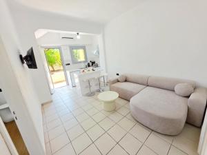 a living room with a couch and a table at Studio Popi in Marathokampos