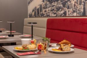 a table with two plates of food on it at Ramada The Hague Scheveningen in Scheveningen