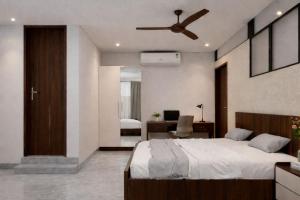 a bedroom with a bed and a ceiling fan at Serene Enclave in Nedumbassery