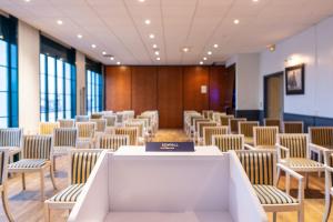 a room with rows of chairs and a table at SOWELL HOTELS Le Beach in Trouville-sur-Mer +72 photos