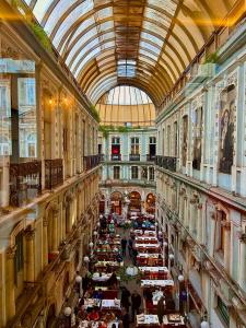 a large room with tables in a building with a ceiling at Hotel Gritti Pera & Spa in Istanbul
