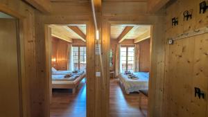 a room with two beds in a wooden house at Chalet Veronique Private Sauna & FREE SaastalCard in Saas-Fee