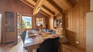a long dining room with a long table and chairs at Chalet Veronique Private Sauna & FREE SaastalCard in Saas-Fee