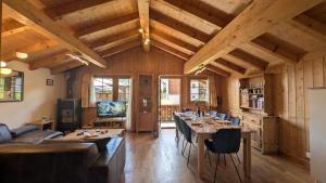 a dining room with a long table and chairs at Chalet Veronique Private Sauna & FREE SaastalCard in Saas-Fee