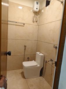 a bathroom with a toilet and a shower at Kerala dormitory edapally in Cochin