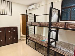 a room with three bunk beds in a dorm room at Kerala dormitory edapally in Cochin