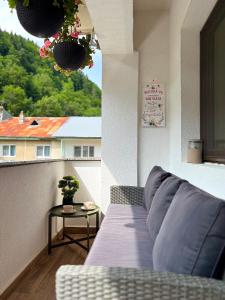 a living room with a couch and a table at Green Escape in Slănic-Moldova