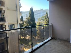 an apartment balcony with a view of a city at Guest Apart in Ozurgetʼi +5 photos