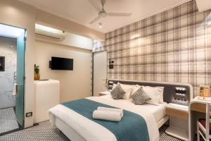 a bedroom with a large bed and a tv at MG Villa - A Boutique Stay in Navi Mumbai +33 photos
