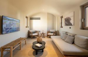 a living room with a couch and a table at Radisson Blu Zaffron Resort, Santorini in Kamari