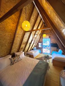 a attic room with a bed and a couch at Ioannina Camping- Glamping in Néon Bizánion +94 photos