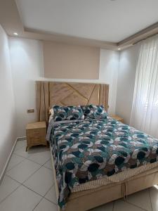 a bedroom with a bed with a quilt on it at Apartment with pool in Asilah +12 photos