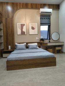 a bedroom with a large bed and a window at LaiKa in Phú Quốc