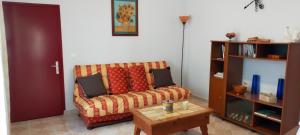 a living room with a couch and a table at Chez Dany et Alain in Brouzet-lès-Alès