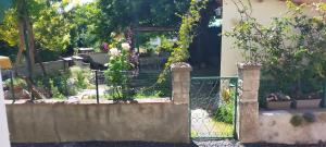 a fence with a bunch of flowers on it at Chez Dany et Alain in Brouzet-lès-Alès