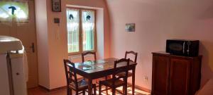 a dining room with a table and a microwave at Chez Dany et Alain in Brouzet-lès-Alès