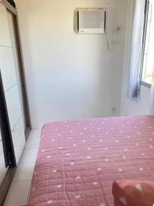 a bedroom with a bed and a window and a fan at Apto no Janga in Paulista +2 photos