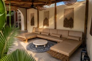 a living room with a couch and a coffee table at DILAW Villa avec piscine privée in El Nido
