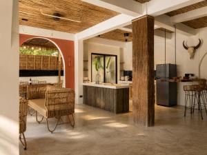 a kitchen with a table and chairs in a room at DILAW Villa avec piscine privée in El Nido