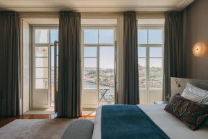a bedroom with a bed and a large window at Torel Private Collection in Porto +188 photos