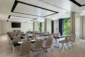 a conference room with tables and chairs and a screen at Excelsior Hotel Gallia, a Luxury Collection Hotel, Milan in Milan +144 photos