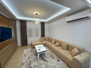 a living room with a couch and a table at Villa Preka in Durrës