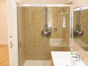 a shower with a glass door next to a sink at Riviera AlbaChiara B&b in Anzio