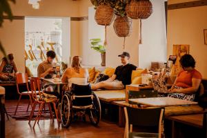 a group of people sitting at a table in a room at Wombat's City Hostel Vienna Naschmarkt in Vienna +42 photos