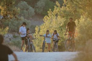 a group of people riding bikes on a dirt road at Makryammos in Limenas