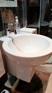 a white sink in a bathroom with a mirror at VianasHome in Amarante +48 photos