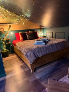 a bedroom with a large bed in a room at Le grenier des sorciers in Balbigny