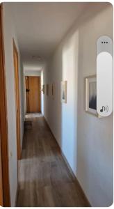 an empty room with a hallway with a hard wood floor at Under the Mediterranean sky in Terrassa