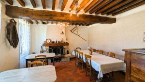 a restaurant with two tables and chairs in a room at Les Chambres de Grangette in Thury