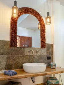 a bathroom with a sink and a mirror at DILAW Villa avec piscine privée in El Nido +23 photos