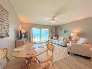 a living room with a table and a couch at Vacation Villas #432 - Beachfront Condo in Fort Myers Beach