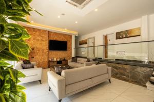 a living room with two couches and a tv at Laristone Suite Spa Hotel in Antalya +54 photos