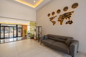 a living room with a couch and a map on the wall at Laristone Suite Spa Hotel in Antalya