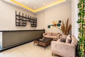 a living room with a couch and a table at Laristone Suite Spa Hotel in Antalya
