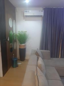 a living room with a couch and a plant at Jasper luxury homes in Abuja