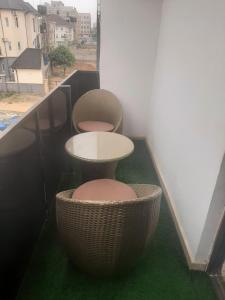 two chairs and a table on a balcony at Jasper luxury homes in Abuja