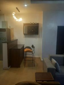 a living room with a couch and a table and a stool at Jasper luxury homes in Abuja