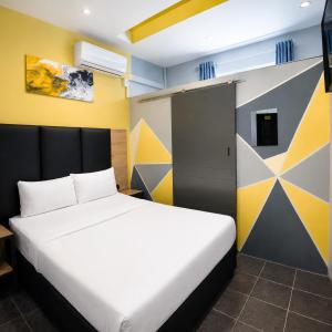 a bedroom with a large bed and a door at Hotel Metro Lodge Xpress in Durban