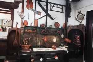 a room with a table and various items on the wall at Etno kuća Teodora in Staji°evo