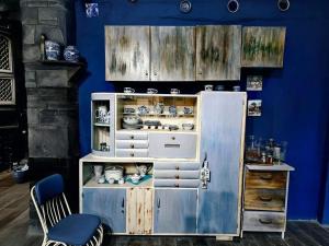 an old refrigerator in a room with a blue wall at Etno kuća Teodora in Staji°evo +46 photos