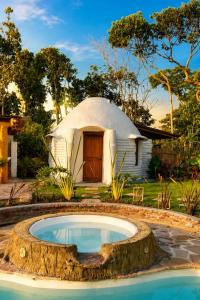 a round pool in front of a dome house at Aldea Ancestral by ID Hotel in Barbosa
