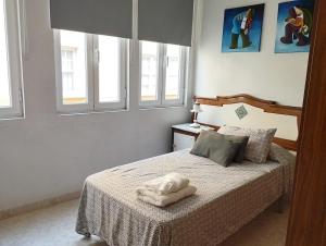 a bedroom with a bed with two towels on it at Eco Mar - Cedeira in Cedeira