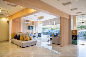 a lobby with couches and chairs and a car dealership at AlQasr - Almansak in Abha