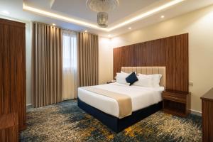 a hotel room with a large bed and a window at AlQasr - Almansak in Abha